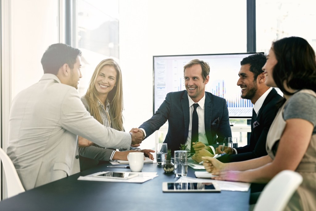 business people shaking hands in a meeting for sponsorship