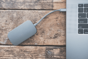 Gray External Drive Mounted on Laptop