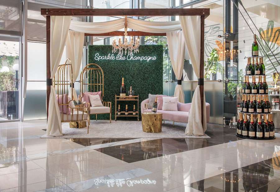 A room with floor-to-ceiling windows at the JW Marriott Los Angeles L.A. Live features an indoor gazebo complete with an opulent seating area and towers of champagne.
