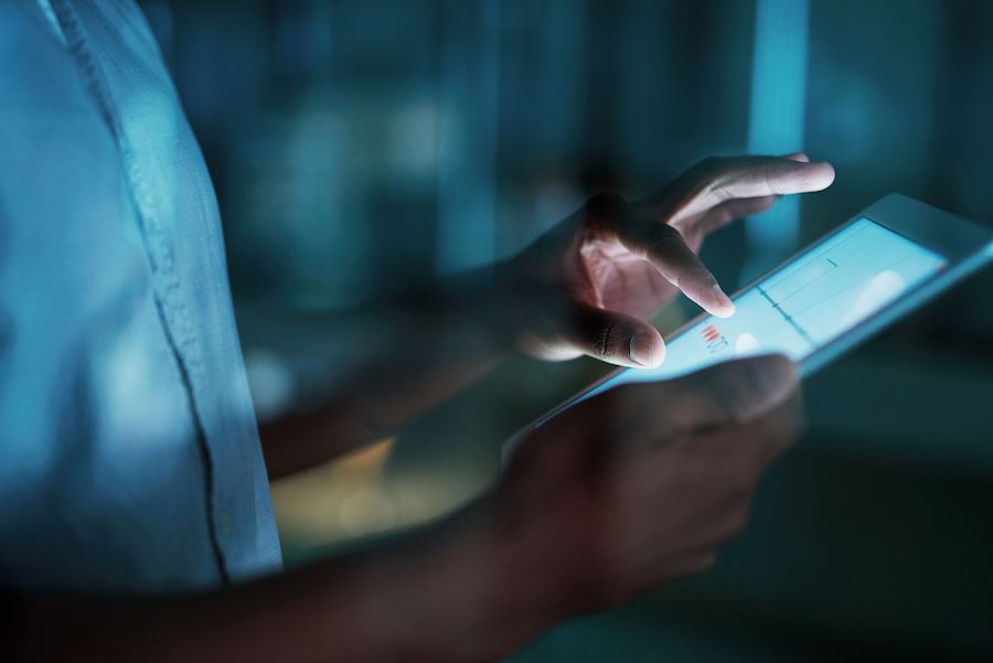 An event organizer reviews data on a tablet device, in keeping with the show floor event trend towards better analytics and more streamlined solutions.
