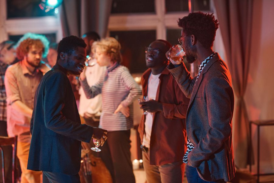 Three attendees mingle in the foreground with several others visible in the background at a networking cocktail hour, demonstrating the show floor trend towards more quality face-to-face time and few wasted minutes in line.