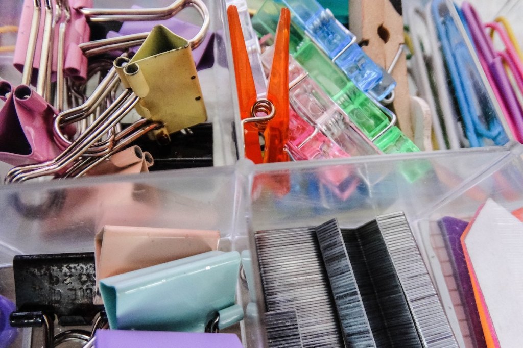 Assorted color plastic container on stainless steel rack photo