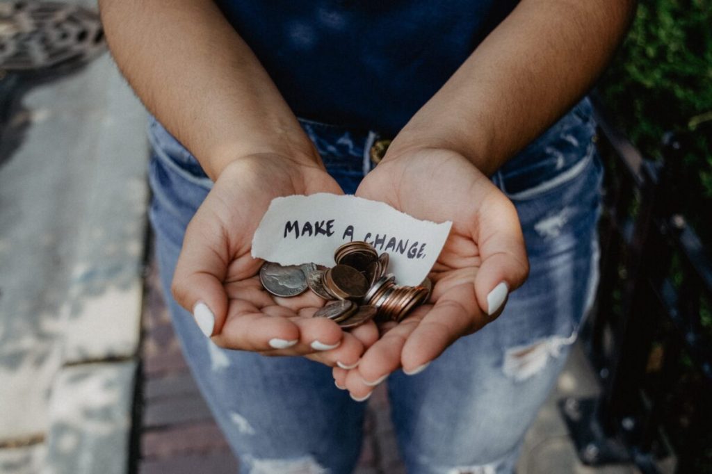 Hands outstretched with change in them as an alternative to boycotts