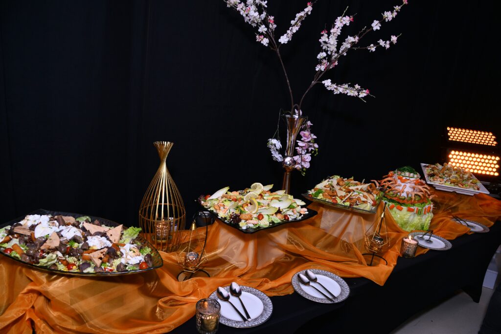 a buffet table at an event with a variety of food on it