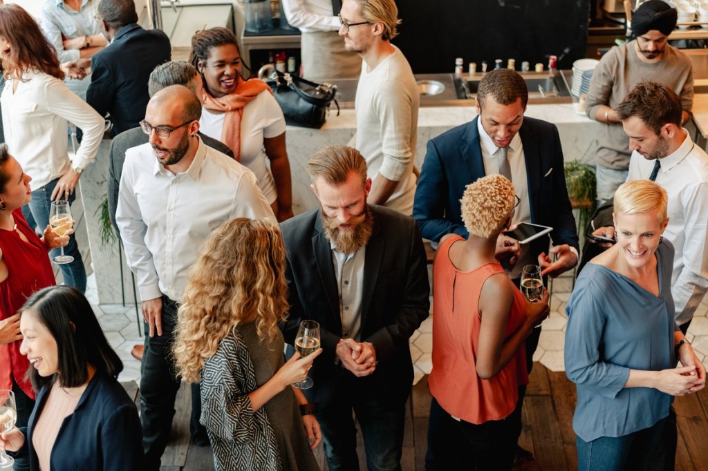 a large professional crowd networking at an event