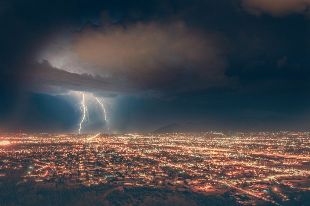 Lightning striking a city at dawn